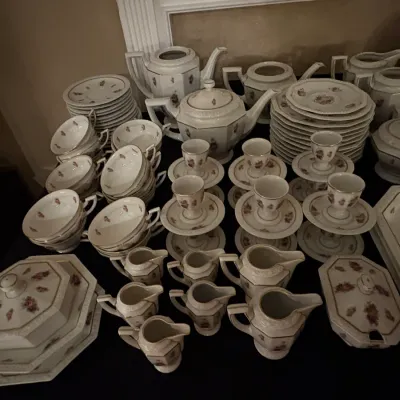 Sale Photo Thumbnail #26: Large vintage porcelain dinnerware set featuring delicate floral motifs, gold trim accents, octagonal serving pieces, teacups, egg cups, and creamers.