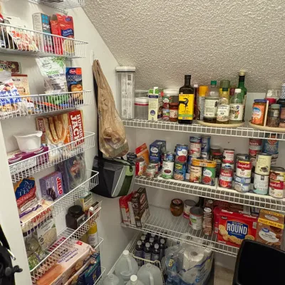 Sale Photo Thumbnail #50: Walk-in pantry fully stocked with various canned goods, boxed dry foods, baking supplies, and paper products