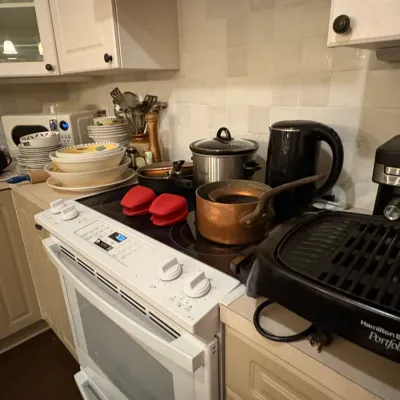 Sale Photo Thumbnail #38: Kitchen counter assortment featuring small appliances including a Hamilton Beach Portfolio indoor grill, slow cooker, electric kettle, coffee machine, and copper cookware.