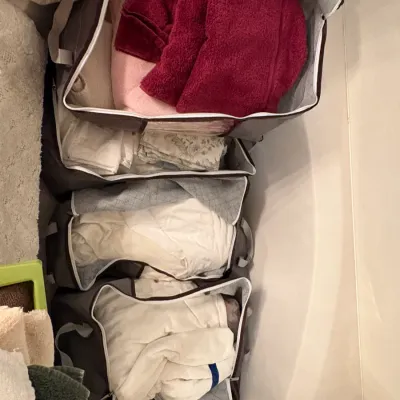 Sale Photo Thumbnail #61: Collection of fabric storage bins filled with household linens, towels, and bedding.