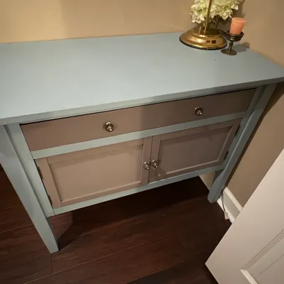 Sale Photo Thumbnail #73: Two-tone painted console table featuring a light blue frame with taupe drawer and cabinet doors, completed with silver hardware.