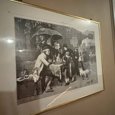 Sale Photo Thumbnail #72: Framed black-and-white vintage art print depicting a busy street market scene, housed in a thin gold-tone metal frame.