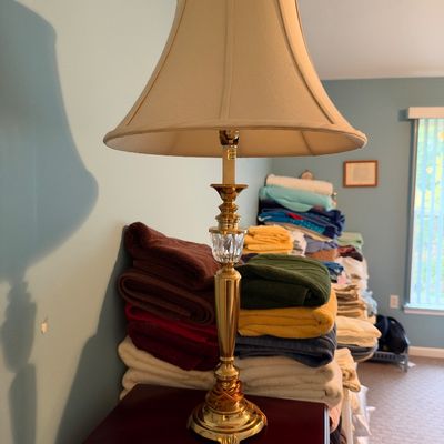 Sale Photo Thumbnail #27: Traditional brass table lamp featuring a clear cut-glass detail on the column and a cream bell shade.