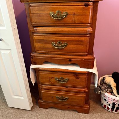 Sale Photo Thumbnail #54: Pair of traditional-style wooden nightstands with brass bail handles stacked on top of each other, showing a warm honey finish.