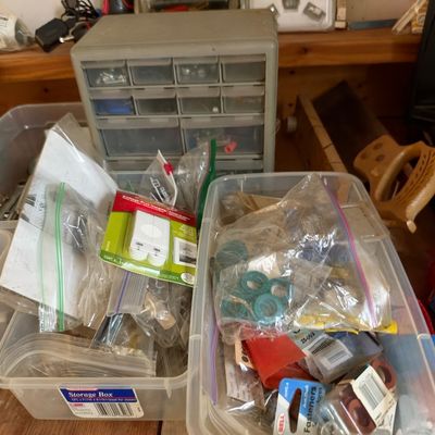 Sale Photo Thumbnail #10: Workshop organizer bins filled with bagged hardware, fasteners, and small tools, paired with a multi-drawer plastic parts cabinet.