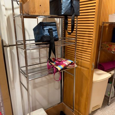 Sale Photo Thumbnail #117: Tall chrome wire shelving unit holding soft-sided coolers, a wooden caddy, and a small hard-sided cooler on the bottom.