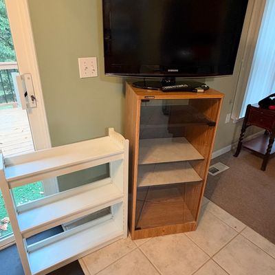 Sale Photo Thumbnail #5: Samsung flat-screen television seated atop a Fisher oak-finish audio/video cabinet with a glass front door, accompanied by a small white three-tier bookshelf.