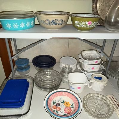 Sale Photo Thumbnail #79: Collection of vintage glassware and kitchenware, including a turquoise Pyrex snowflake casserole dish, avocado green Pyrex bowl, and stoneware bowls.