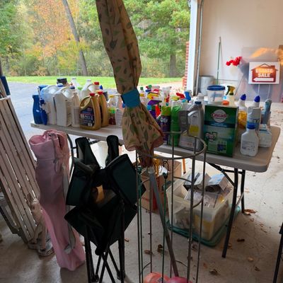 Sale Photo Thumbnail #125: Selection of household cleaning supplies and yard equipment, including motor oil, detergent, folding camp chairs, and a patio umbrella.