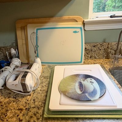 Sale Photo Thumbnail #88: Assorted kitchen prep items, including wooden and plastic cutting boards, a round glass hot plate, a hand mixer, and an immersion blender with whisk attachment.