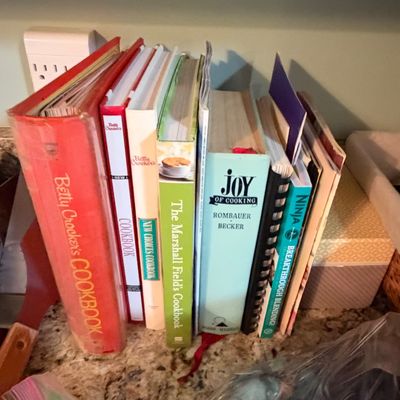 Sale Photo Thumbnail #77: A collection of vintage and modern cookbooks resting on a kitchen countertop, including Betty Crocker's Cookbook and Joy of Cooking.