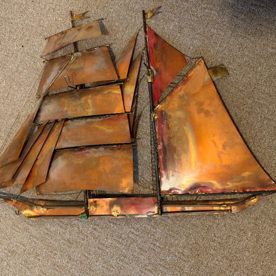 Sale Photo Thumbnail #39: Mid-century metal sailboat wall sculpture featuring layered copper and brass sails with welded wire details.