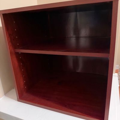 Sale Photo Thumbnail #45: Compact reddish-brown wooden bookshelf or storage cubby featuring one adjustable shelf.