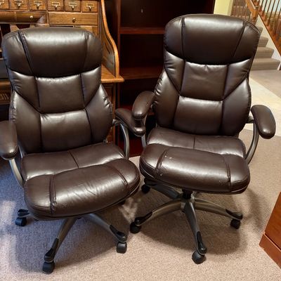 Sale Photo Thumbnail #48: Pair of matching dark brown faux leather executive office chairs with rolling five-star bases.