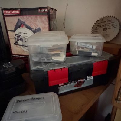 Sale Photo Thumbnail #8: Craftsman 7 1/4-inch circular saw in original box, accompanied by a plastic toolbox, small organizer tubs with hardware, and a saw blade.