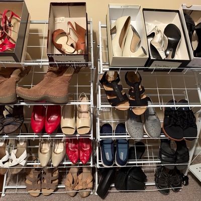Sale Photo Thumbnail #26: A white wire shoe rack displaying an extensive collection of women's footwear, including boots, heels, flats, and sandals.