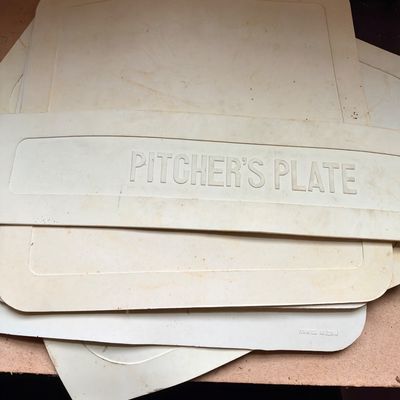 Sale Photo Thumbnail #63: Stack of white rubber baseball bases, including a pitcher's plate and throw-down bases.