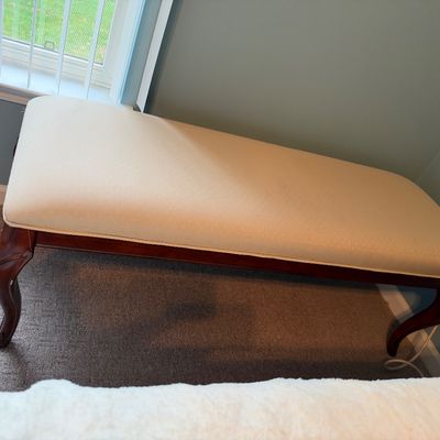 Sale Photo Thumbnail #34: Traditional upholstered bench featuring a cream-colored cushion and dark mahogany-finished cabriole legs.