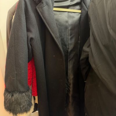 Sale Photo Thumbnail #61: Black full-length coat featuring black faux fur trim around the collar and cuffs.