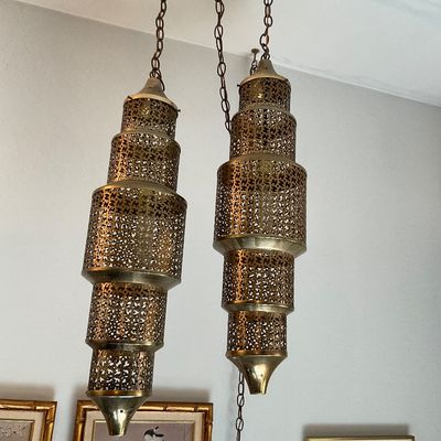 Sale Photo Thumbnail #137: Vintage Moroccan-style dual pendant light fixture featuring tiered pierced brass lanterns suspended from chains.