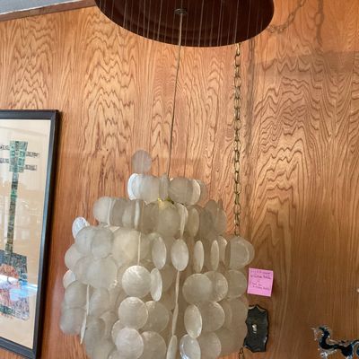 Sale Photo Thumbnail #157: Vintage capiz shell cascade pendant swag light with a circular wooden top cap and chain cord.