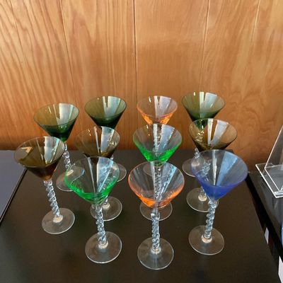 Sale Photo Thumbnail #158: Set of vintage colorful glass martini stemware with twisted clear glass stems, featuring a variety of jewel-toned bowls.