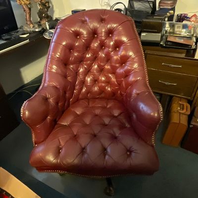 Sale Photo Thumbnail #130: Vintage Chesterfield-style high-back executive desk chair upholstered in burgundy tufted leather with brass nailhead trim.