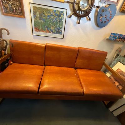 Mid-century Danish modern style sofa featuring warm cognac faux leather upholstery, one  spot - as is 