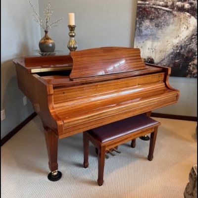 Sale Photo Thumbnail #5: Stunning Story & Clark Prelude baby grand piano has a polished mahogany wood finish. This instrument is a Prelude model with a matching padded bench. The piano has a high-gloss exterior and brass hardware.
Approx 5x5 feet. 
Buyer pays moving costs.