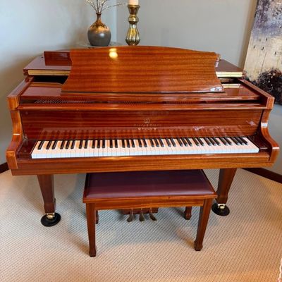 Sale Photo Thumbnail #2: Stunning Story & Clark Prelude baby grand piano has a polished mahogany wood finish. This instrument is a Prelude model with a matching padded bench. The piano has a high-gloss exterior and brass hardware.
Approx 5x5 feet. 
Buyer pays moving costs.
