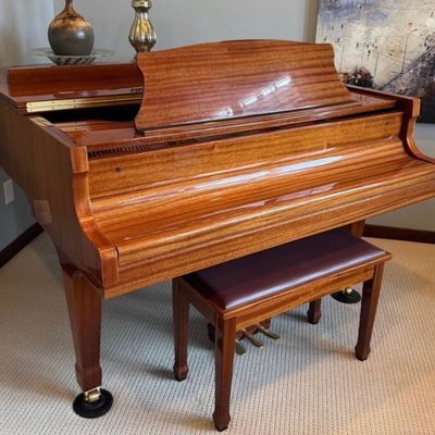 Sale Photo Thumbnail #8: Stunning Story & Clark Prelude baby grand piano has a polished mahogany wood finish. This instrument is a Prelude model with a matching padded bench. The piano has a high-gloss exterior and brass hardware.
Approx 5x5 feet. 
Buyer pays moving costs.