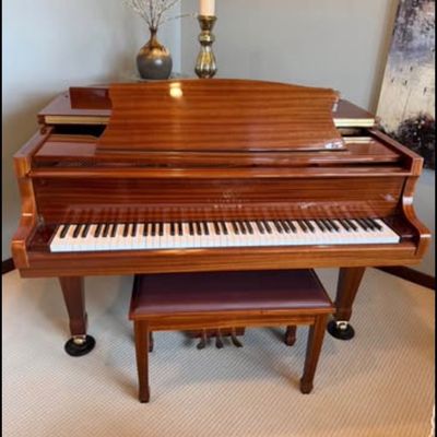 Sale Photo Thumbnail #4: Stunning Story & Clark Prelude baby grand piano has a polished mahogany wood finish. This instrument is a Prelude model with a matching padded bench. The piano has a high-gloss exterior and brass hardware.
Approx 5x5 feet. 
Buyer pays moving costs.