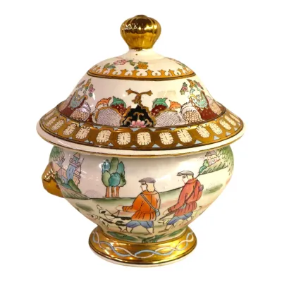 Sale Photo Thumbnail #276: Hand-painted porcelain covered tureen featuring a European hunting scene with gilt trim and a decorative finial.