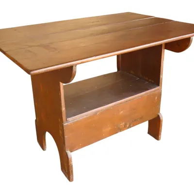 Sale Photo Thumbnail #239: Antique rustic pine bucket bench table with a plank top and lower shelf storage, showing age-appropriate finish wear.