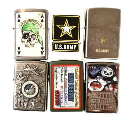 Sale Photo Thumbnail #147: Collection of six Zippo-style metal lighters featuring military, patriotic, and law enforcement themes, including a Caribbean pirate design, U.S. Army insignia, and gun permit graphics.