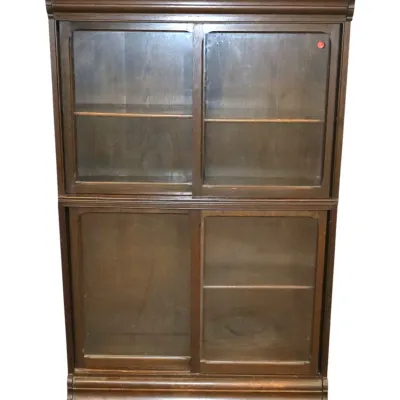 Sale Photo Thumbnail #234: Vintage dark wood display cabinet featuring sliding glass pane doors and interior shelving.
