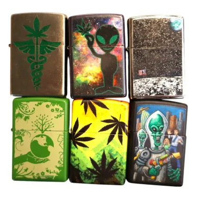 Sale Photo Thumbnail #168: Collection of six Zippo-style metal lighters featuring various alien, space, and cannabis graphic designs.