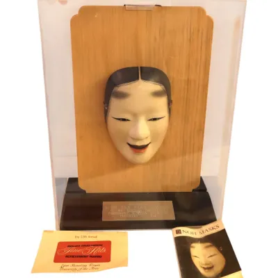 Sale Photo Thumbnail #51: Japanese Noh mask award presented mounted on a light wood plaque inside a clear acrylic display case, accompanied by a Noh Masks booklet and award paperwork.