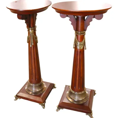 Sale Photo Thumbnail #228: Pair of Neoclassical style wooden pedestal plant stands featuring brass drapery accents, fluted columns, and metal claw feet.