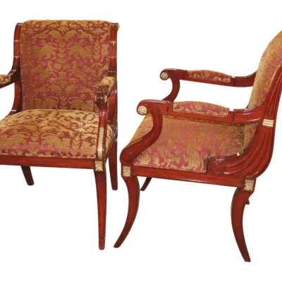 Sale Photo Thumbnail #274: Pair of Neoclassical-style mahogany armchairs featuring carved details with gilt accents and red and gold patterned upholstery.