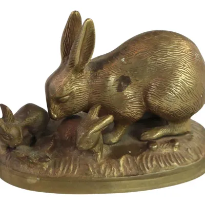 Sale Photo Thumbnail #106: Vintage solid brass figurine depicting a mother rabbit with two bunnies on an oval base, featuring detailed fur texture and natural patina.