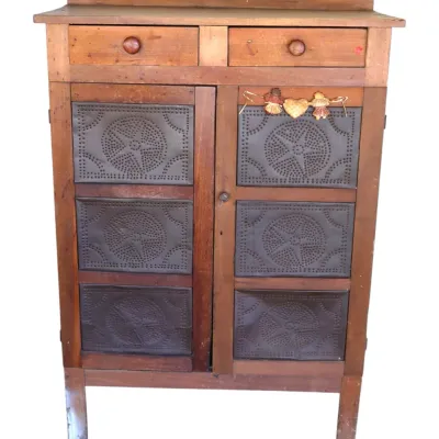 Sale Photo Thumbnail #241: Rustic wooden pie safe featuring punch-tin star design door panels and two top drawers.