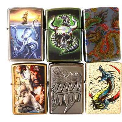 Sale Photo Thumbnail #184: Collection of six Zippo-style lighters featuring fantasy and nautical graphics, including dragons, a pirate, an octopus, and a horned skull.