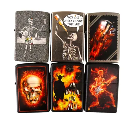 Sale Photo Thumbnail #156: Set of six Zippo-style windproof lighters featuring skeleton, fiery skull, and dark fantasy graphics in good pre-owned condition.