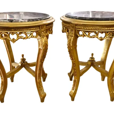 Sale Photo Thumbnail #227: Pair of French ornate giltwood side tables featuring round dark marble inset tops, cabriole legs, and elaborate carved aprons with central stretchers.
