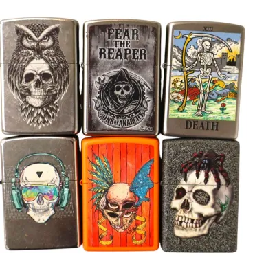 Sale Photo Thumbnail #194: Collection of six Zippo-style lighters with skull and grim reaper graphics, including Sons of Anarchy and tarot themes.