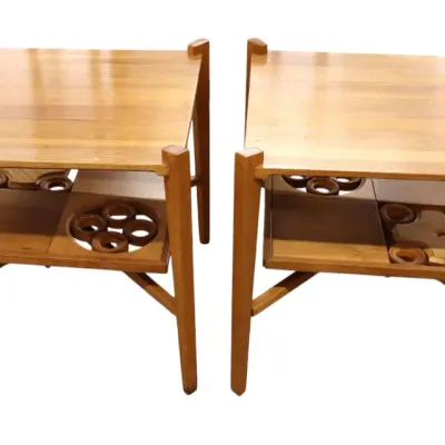 Sale Photo Thumbnail #38: Pair of mid-century modern walnut wooden end tables featuring geometric lower shelves with decorative circle cutouts.