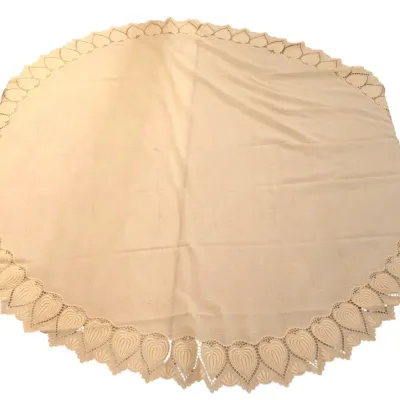 Sale Photo Thumbnail #202: Round cream-colored tablecloth featuring a subtle stitched grid pattern and an ornate cutwork heart border.