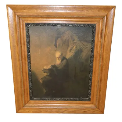 Sale Photo Thumbnail #125: Framed Rembrandt-style oil painting depicting an elderly bearded scholar seated and reading, set within a dark inner liner and a wide light oak wood frame.