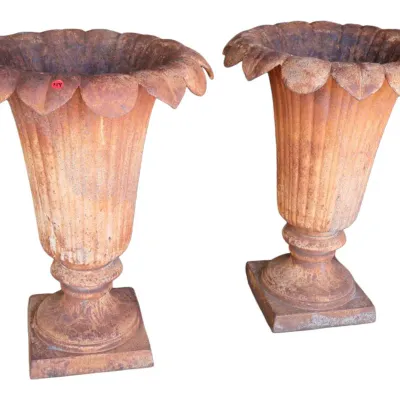 Sale Photo Thumbnail #260: Pair of vintage rusted cast iron urn planters with fluted bodies and scalloped rims on square pedestal bases.